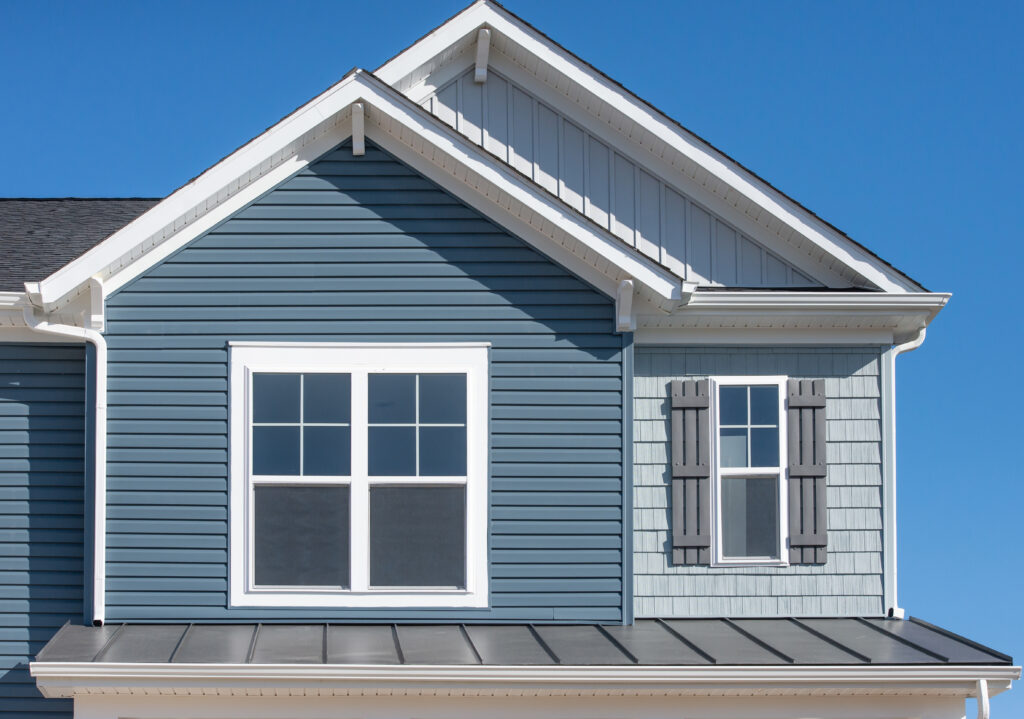 single family home with natural wood finish and blue sky behind it