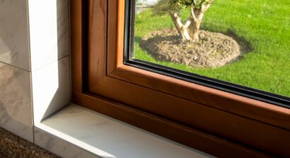 a corner of a home with solid wood window