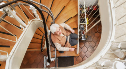 elderly woman using stairlift