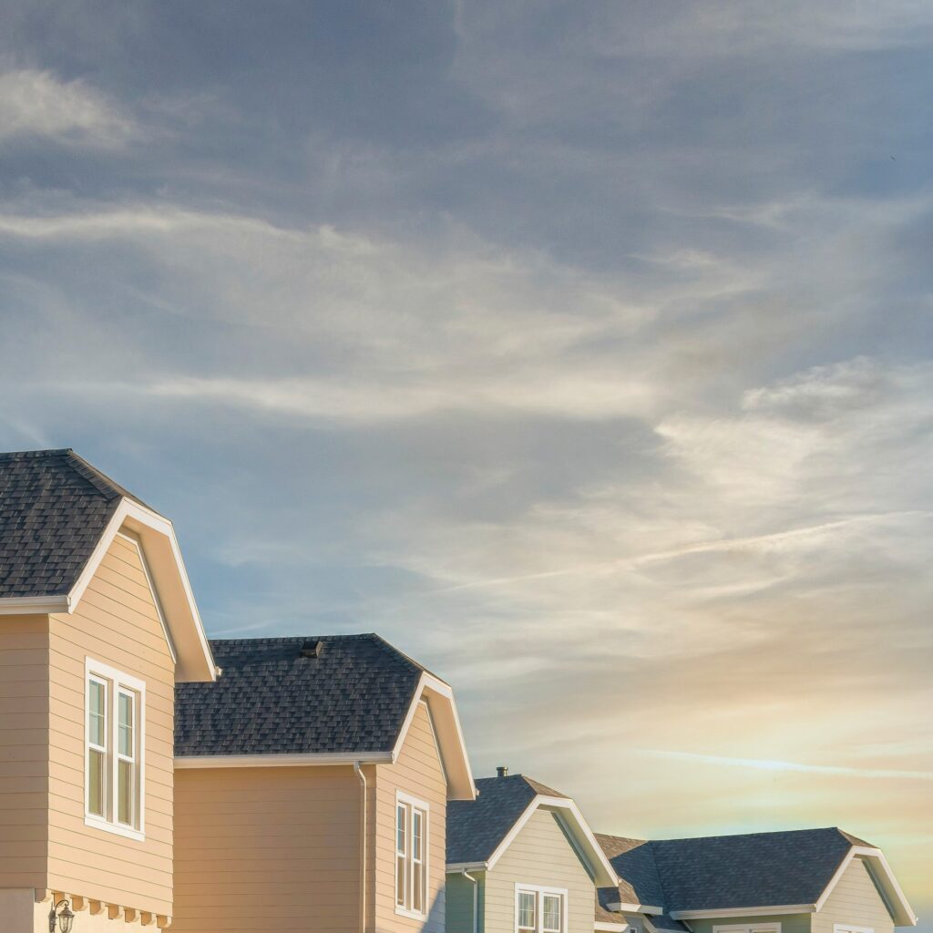 row of houses with skyline and clouds in background