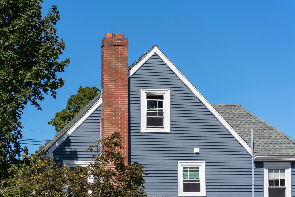 home with gable roof and blue siding