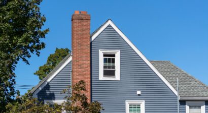 home with gable roof and blue siding