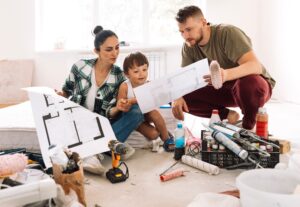 woman with her child and husband sitting taking a look at floor plans