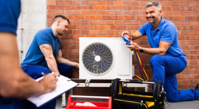 technicians installing hvac unit