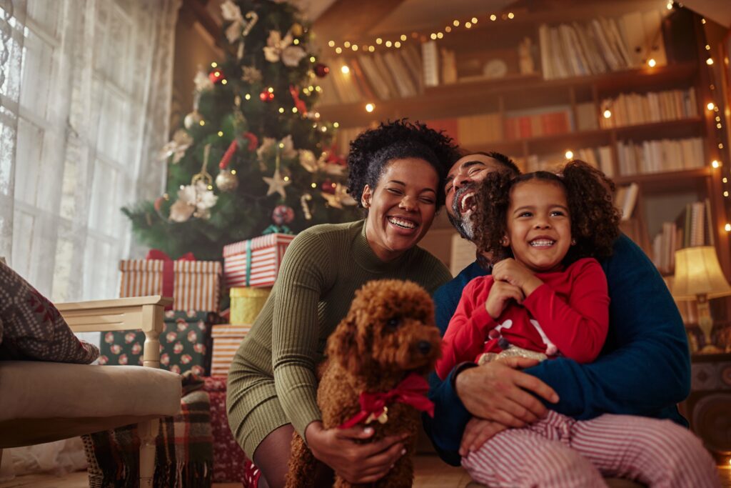 happy family at home in front of christmas tree