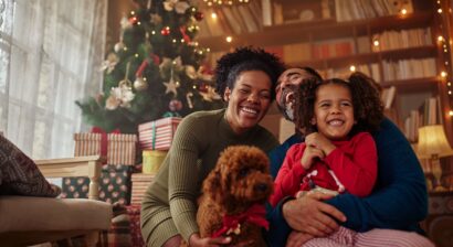 happy family at home in front of christmas tree