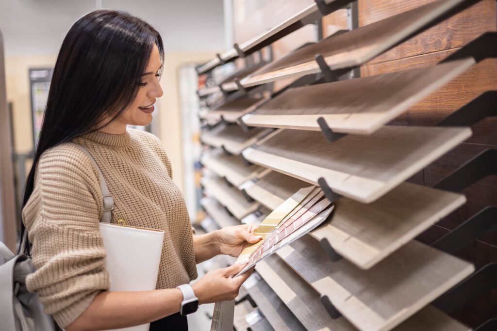 young woman looking at different types of flooring