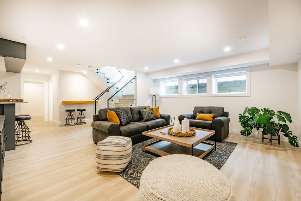 recreated basement with couches and wood floors