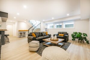 recreated basement with couches and wood floors