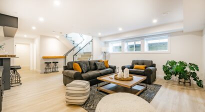 recreated basement with couches and wood floors