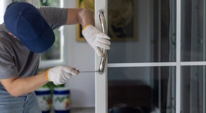 homeowner installing handle on aluminum door