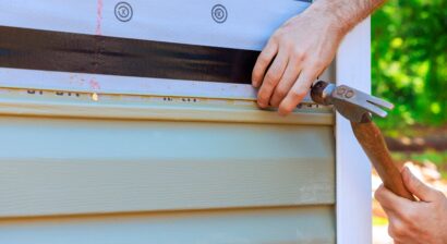 contractor skillfully applying siding to a house