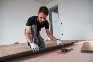 man installing new wooden floors
