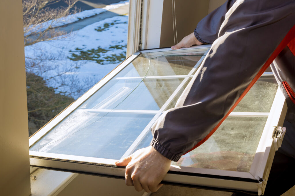 worker replacing a window in a home