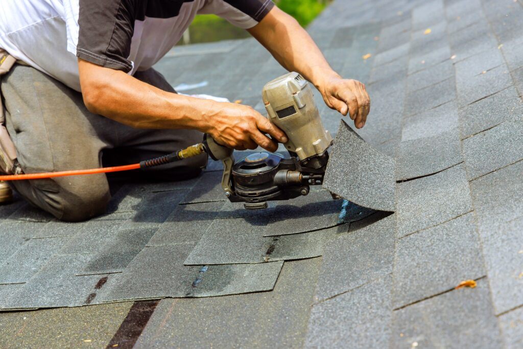 installation of new shingles on a roof