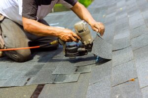 installation of new shingles on a roof