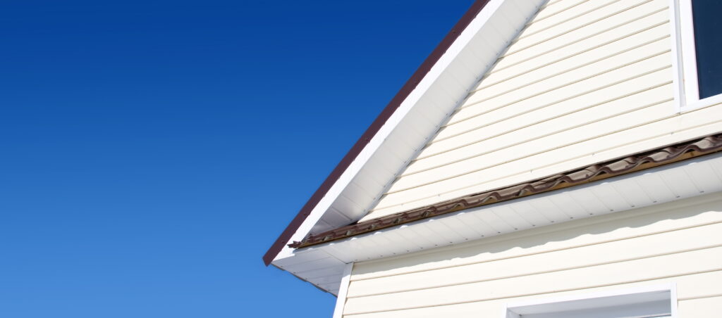siding on edge of a home with blue sky