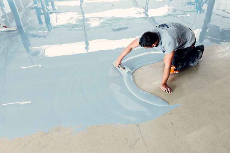 construction worker on the ground with epoxy flooring