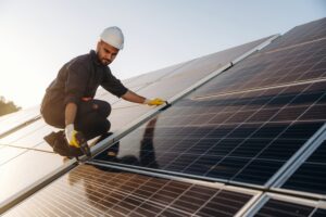 professional solar installer on a roof with panels