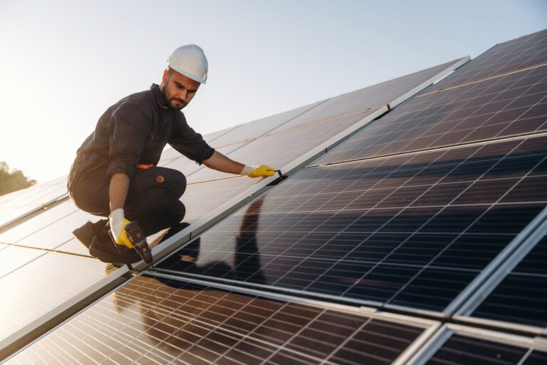 professional solar installer on a roof with panels